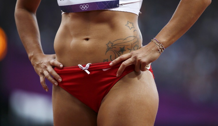 Image: The tattoo of Lebanon's Gretta Taslakian is seen during her women's 200m round 1 heat at the London 2012 Olympic Games at the Olympic Stadium